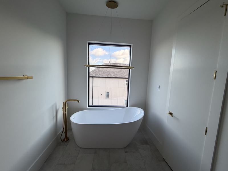 Freestanding bath with floor mounted filler, finished and commissioned