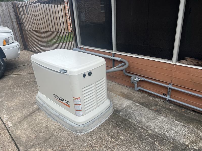 Installed standby generator with gas piping run along the wall