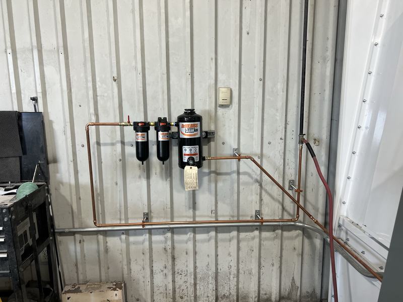 Copper compressed-air piping and air treatment equipment installed at an industrial facility