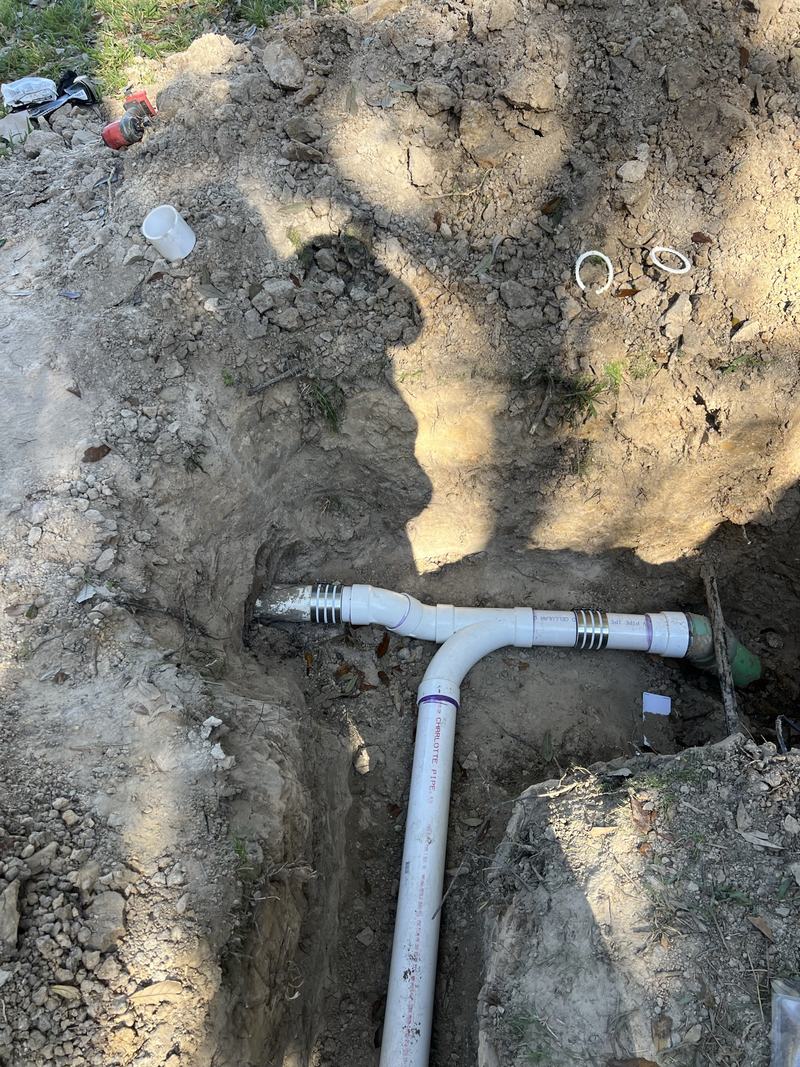 New sewer line fittings set in a trench before backfill