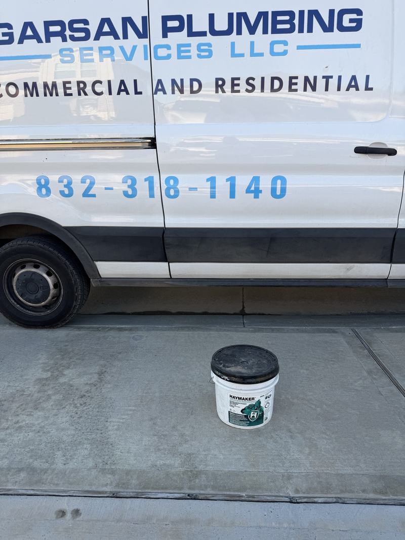 The GarSan Plumbing Services van showing the phone number 832 318 1140