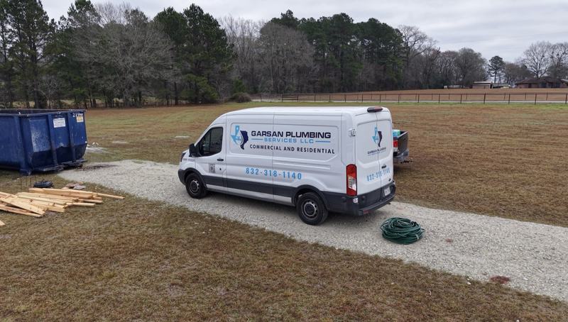GarSan Plumbing Services van at a rural new construction site